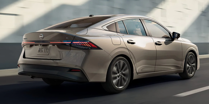 2026 Nissan sedan driving through a city street 